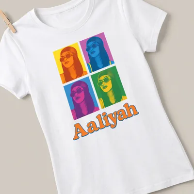 Retro pop art t-shirt featuring the name Aaliyah in bright colors — printed on a women's shirt