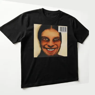 Digital art of a smiling face in brown, black, and white shades — printed on a unisex t-shirt (angled view)