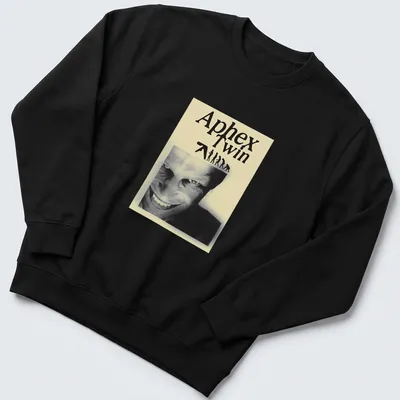 Black and white illustration featuring Aphex Twin text, evolving figures, and a smiling face — printed on a unisex sweatshirt