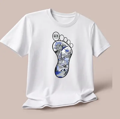 Illustrative beach footprint with ocean elements in blue, black, and gray — printed on a unisex t-shirt (angled view)