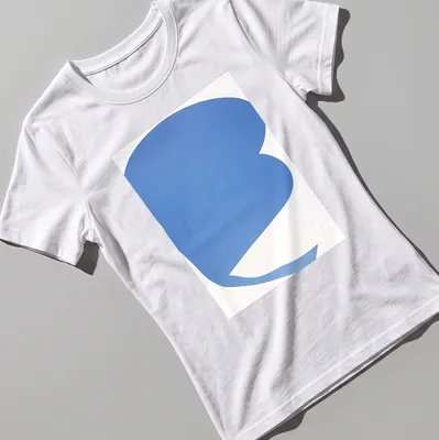 Minimalist t-shirt featuring an abstract blue shape on a white background — printed on a women's shirt