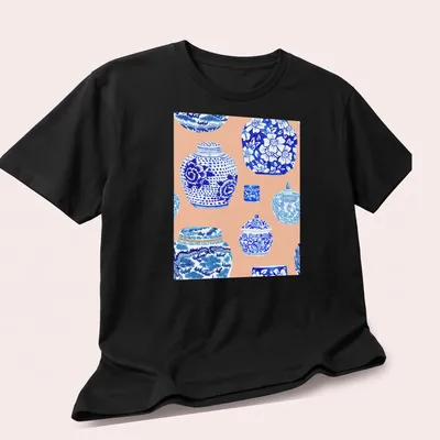 Watercolor print featuring a collection of ginger jars in blue, white, and peach — printed on a unisex t-shirt (angled view)