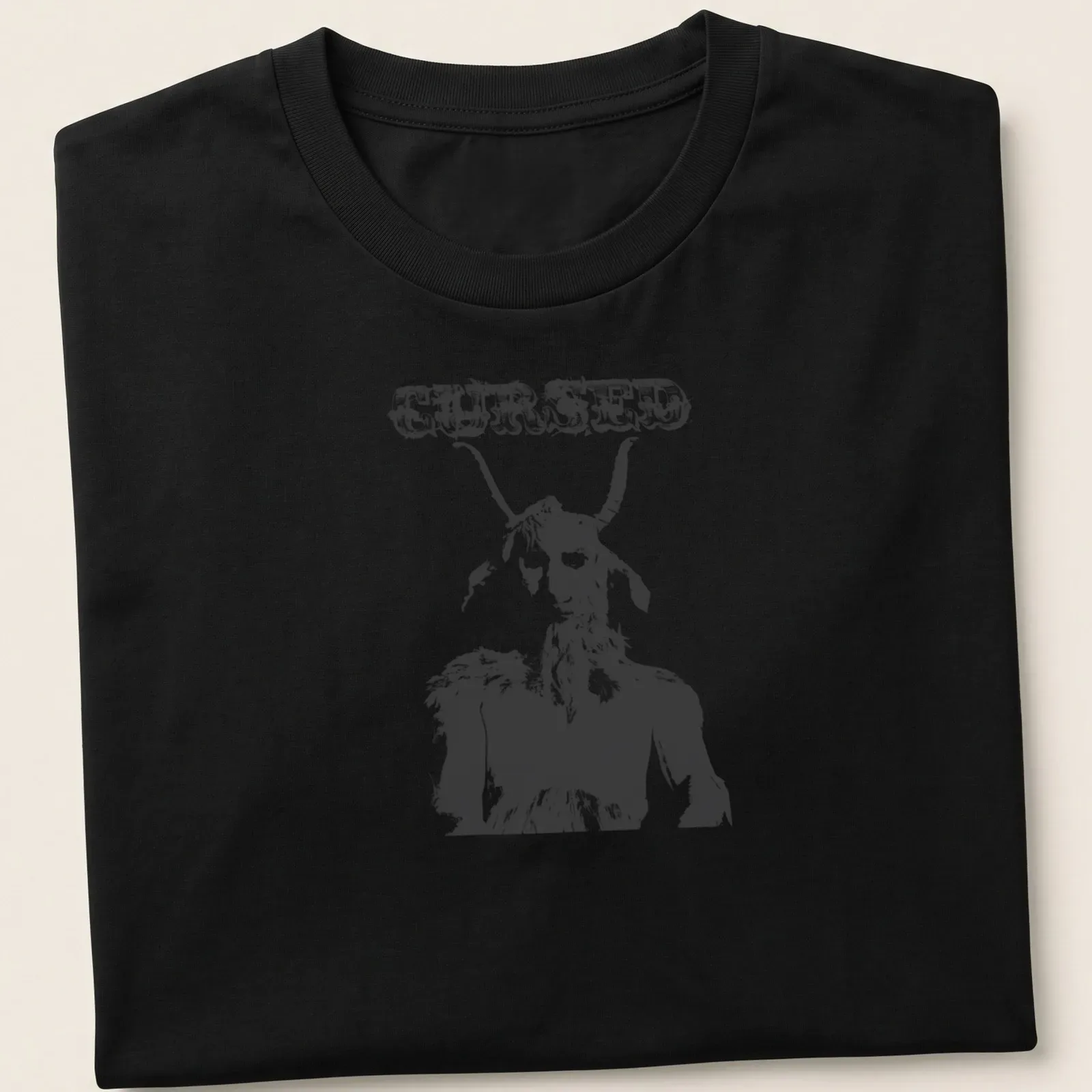 Distressed illustration of a goat creature with the text CURSED in bold letters — printed on a unisex t-shirt