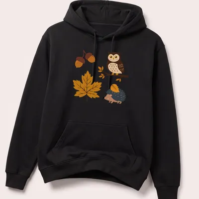 Kawaii design with an owl and hedgehog surrounded by acorns and leaves in autumn colors — printed on a unisex hoodie