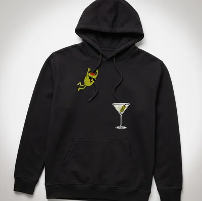Cartoon olive diving into a dirty martini cocktail, illustrated in green, black, white, and red — printed on a unisex hoodie