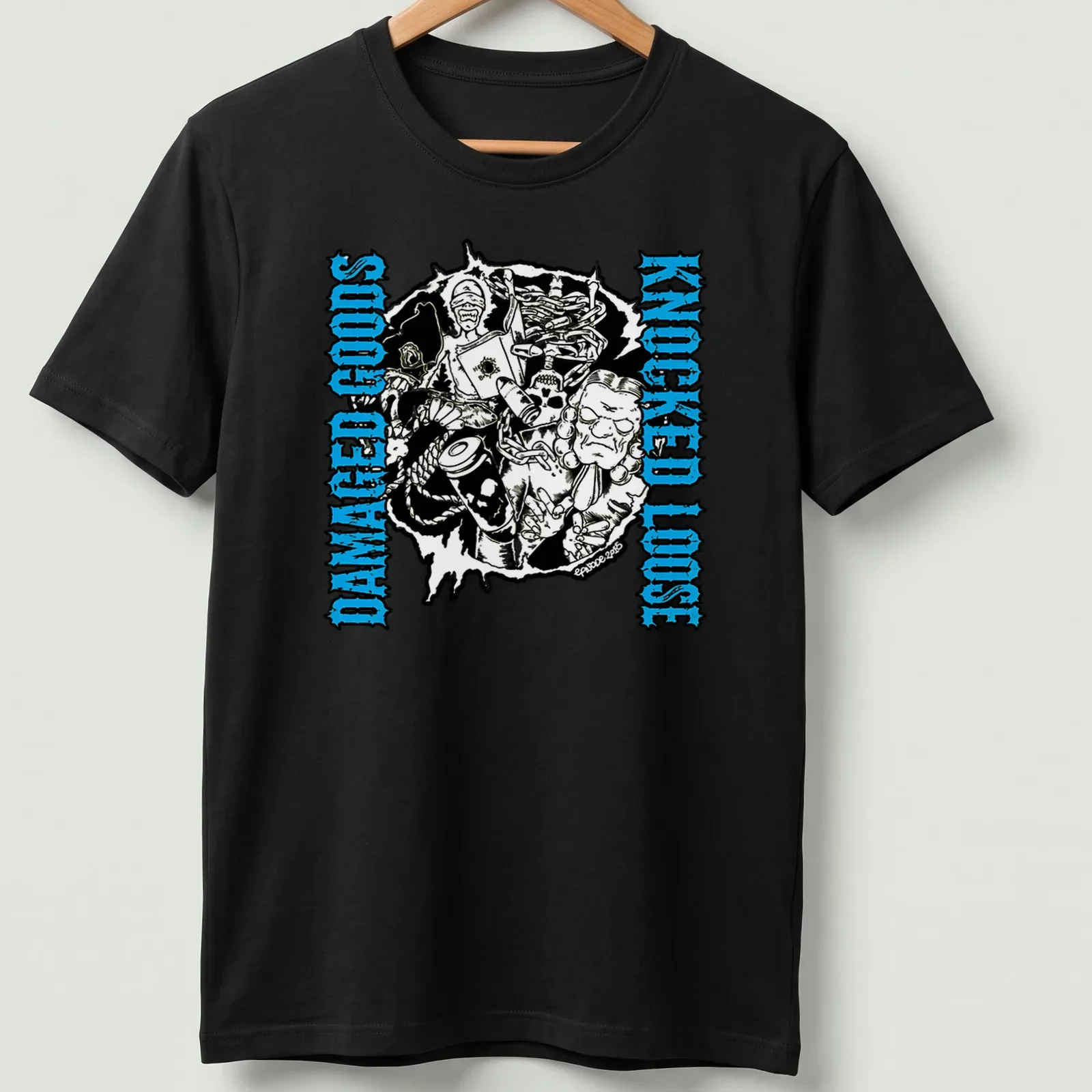 Bold graphic tee with the phrase 'Damaged Goods Knocked Loose' and chaotic illustrated characters in black, blue, and white. — printed on a unisex t-shirt
