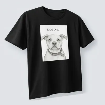 Sketch-style Dog Dad t-shirt featuring a playful dog illustration in monochrome — printed on a unisex t-shirt (angled view)