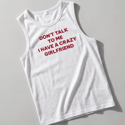Bold typography tee stating Don't Talk To Me I Have A Crazy Girlfriend in red and white — printed on a tank top