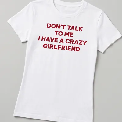 Bold typography tee stating Don't Talk To Me I Have A Crazy Girlfriend in red and white — printed on a women's shirt