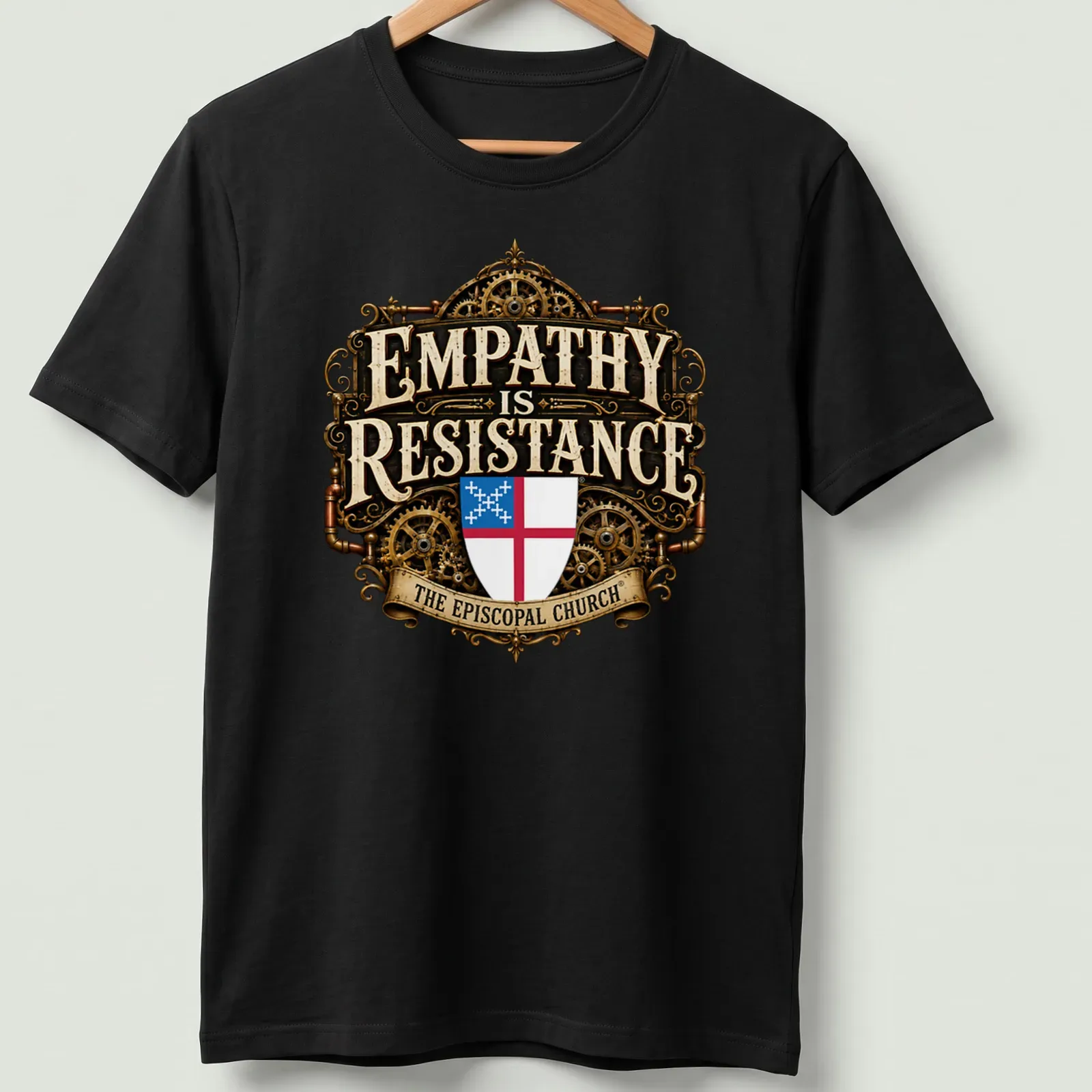 Steampunk shield emblem with ornate text: 'EMPATHY is RESISTANCE THE EPISCOPAL CHURCH' — printed on a unisex t-shirt