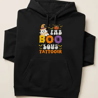 Cartoon ghost with a witch hat and FAB BOO LOUS TATTOOER text in festive colors — printed on a unisex hoodie
