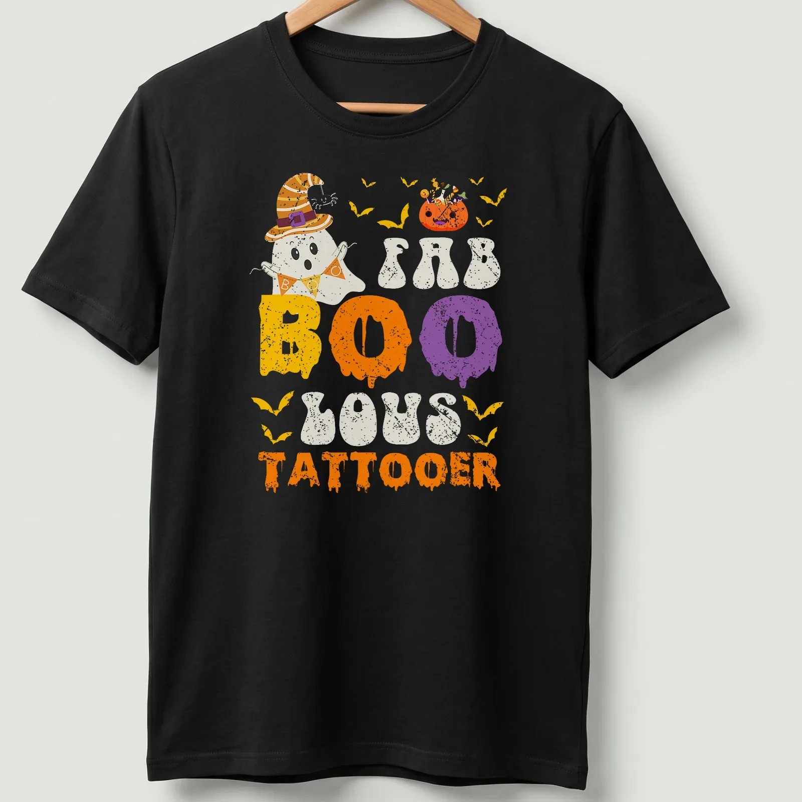 Cartoon ghost with a witch hat and FAB BOO LOUS TATTOOER text in festive colors — printed on a unisex t-shirt