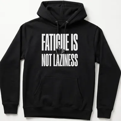 Bold typography tee featuring a coffee cup and the text 'Fatigue Is Not Laziness' in white on a purple background. — printed on a unisex hoodie