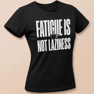 Bold typography tee featuring a coffee cup and the text 'Fatigue Is Not Laziness' in white on a purple background. — printed on a women's shirt