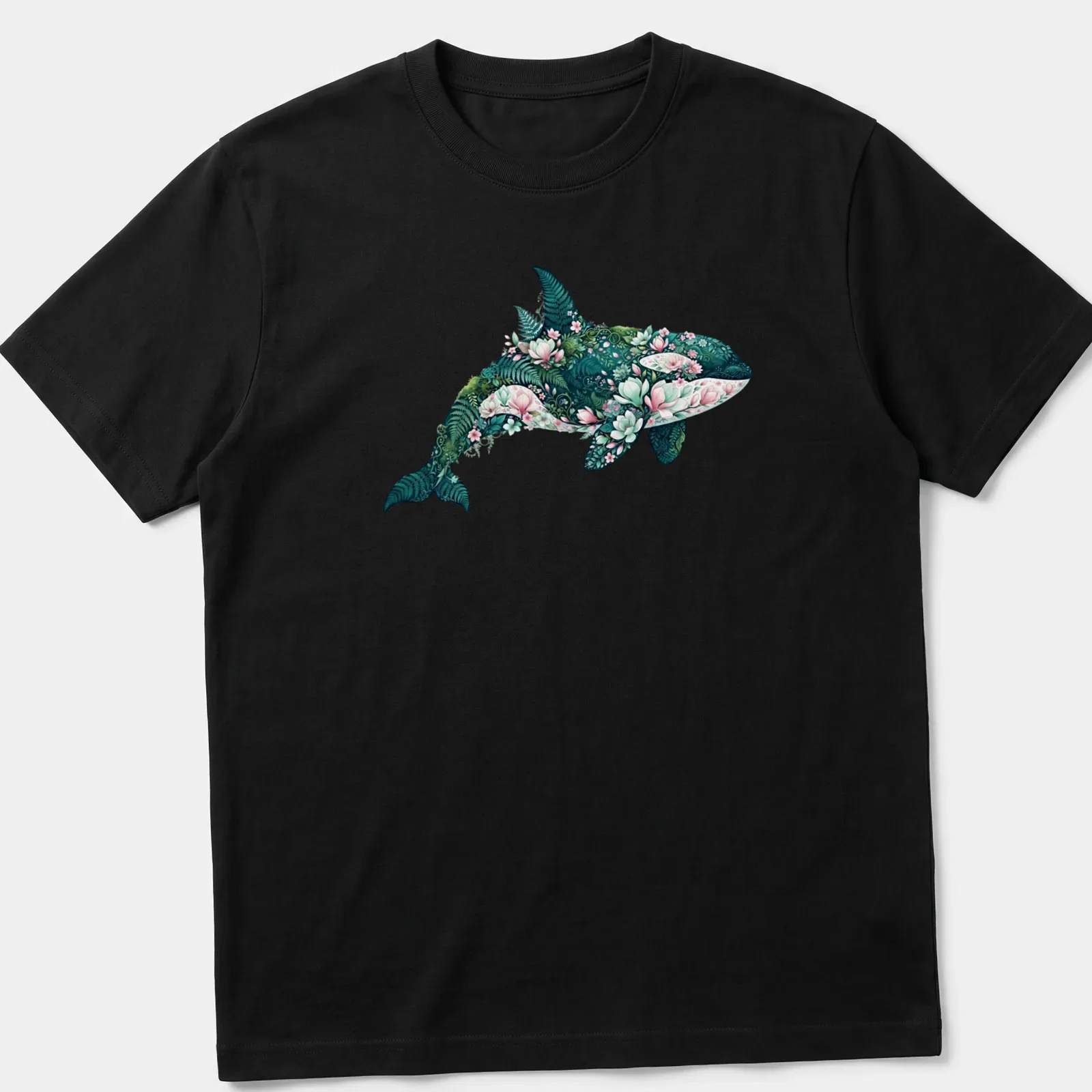 Botanical illustration of an orca whale surrounded by floral elements in teal, pink, and green. — printed on a unisex t-shirt