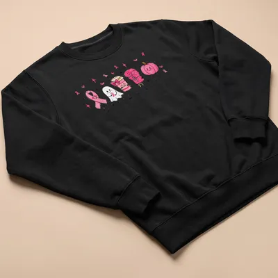 Kawaii illustration of a ghost with a pink ribbon, coffee cup, and pumpkin — printed on a unisex sweatshirt