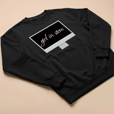Elegant script reading 'girl in stem' in pink and black typography — printed on a unisex sweatshirt