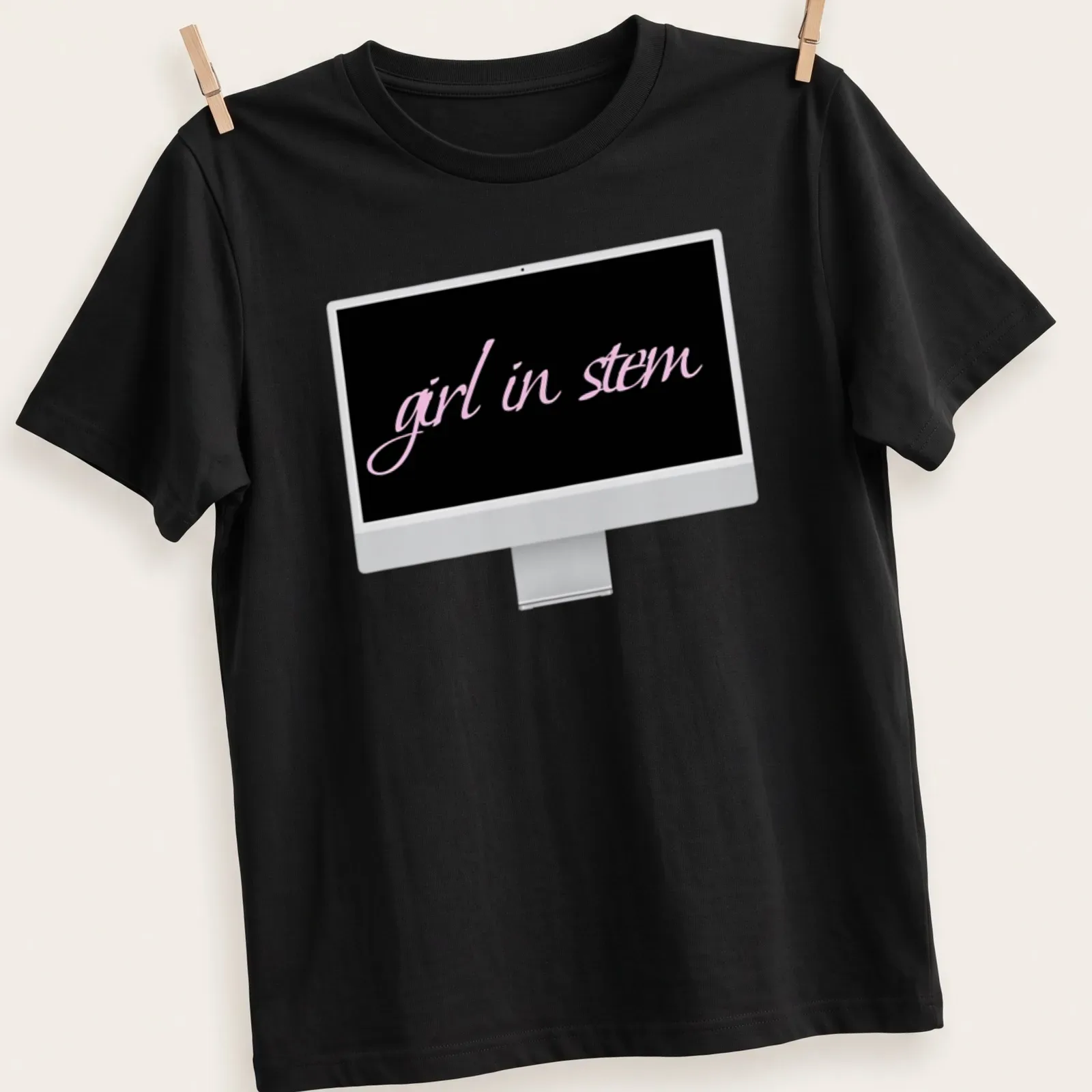 Elegant script reading 'girl in stem' in pink and black typography — printed on a unisex t-shirt