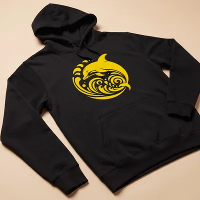 Tribal dolphin design in gold and yellow, leaping through waves — printed on a unisex hoodie