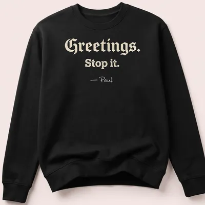Playful script with Christian humor saying 'Greetings. Stop it. - Paul.' on a cream background — printed on a unisex sweatshirt