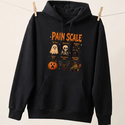 Colorful Halloween design featuring a pain scale with ghosts, a cat, and pumpkins. — printed on a unisex hoodie