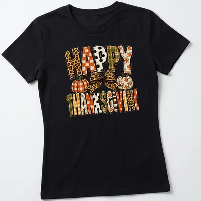 Leopard bow over pumpkins with "Happy Thanksgiving" text in festive colors — printed on a women's shirt
