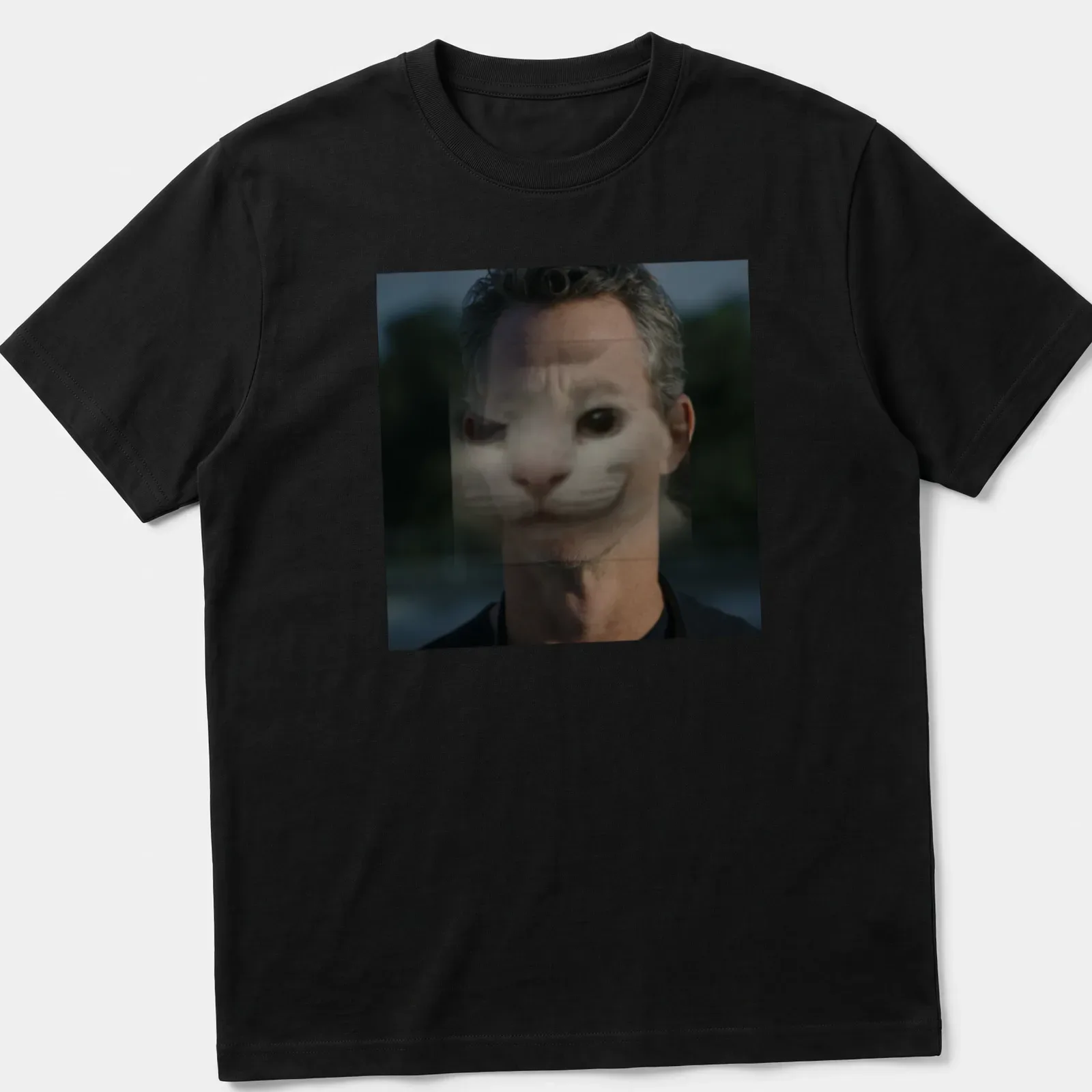 Surreal print featuring a cat face merging with a human face in gray and black — printed on a unisex t-shirt