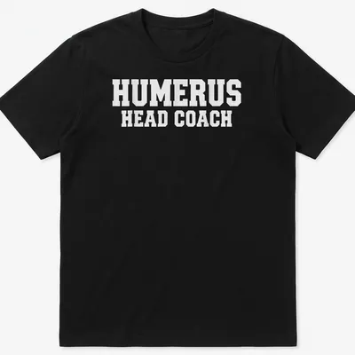 White T-shirt with bold text 'HUMERUS HEAD COACH' and anatomical humerus bone graphic