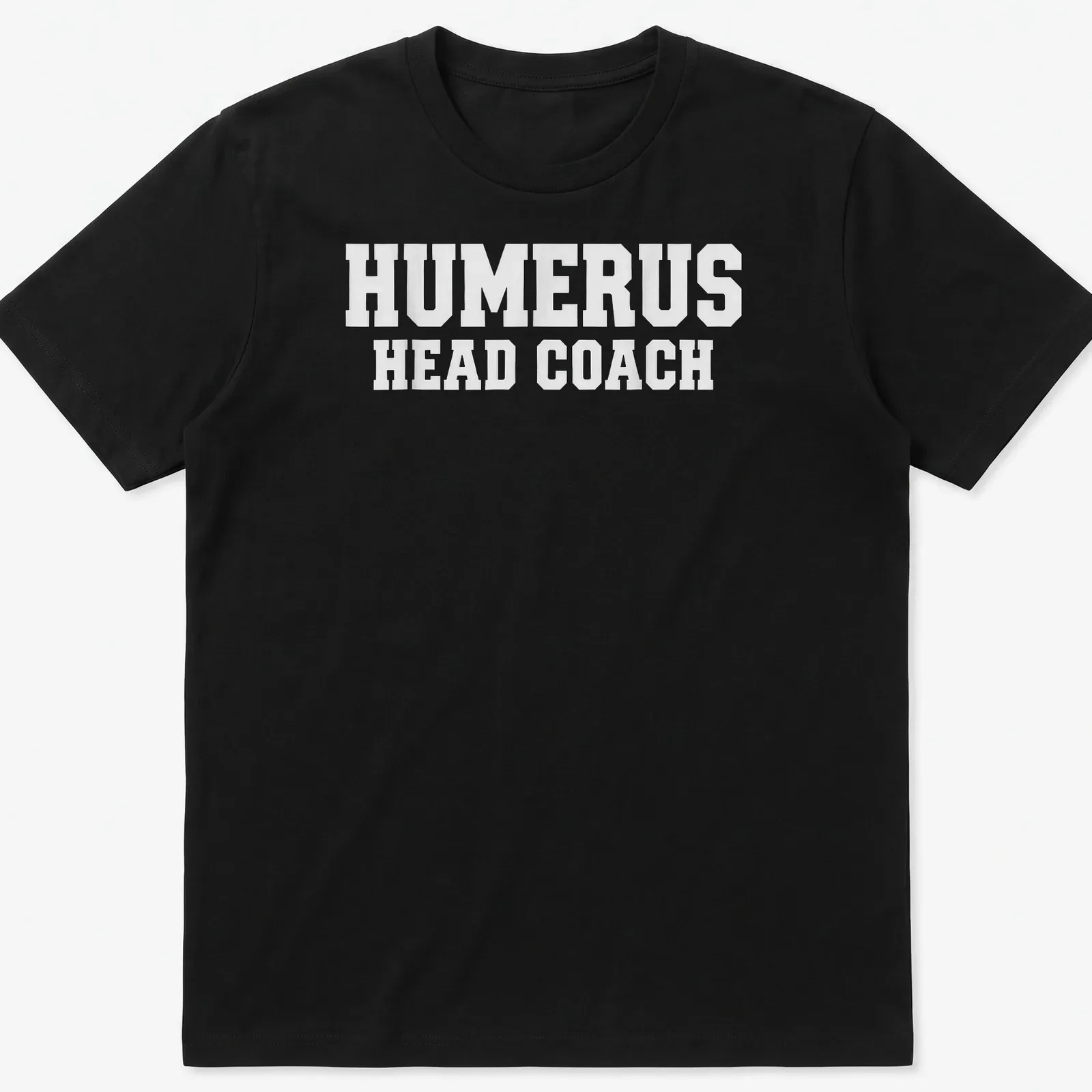 White T-shirt with bold text 'HUMERUS HEAD COACH' and anatomical humerus bone graphic — printed on a unisex t-shirt