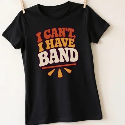 Retro tee with colorful text 'I CAN'T, I HAVE BAND' in orange, yellow, purple, and cream — printed on a women's shirt