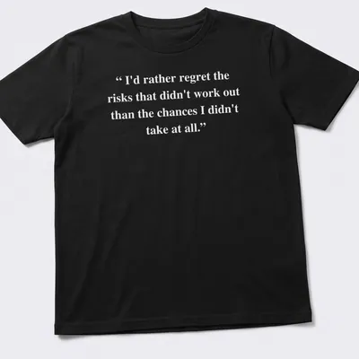 Inspirational text about taking risks printed on a T-shirt