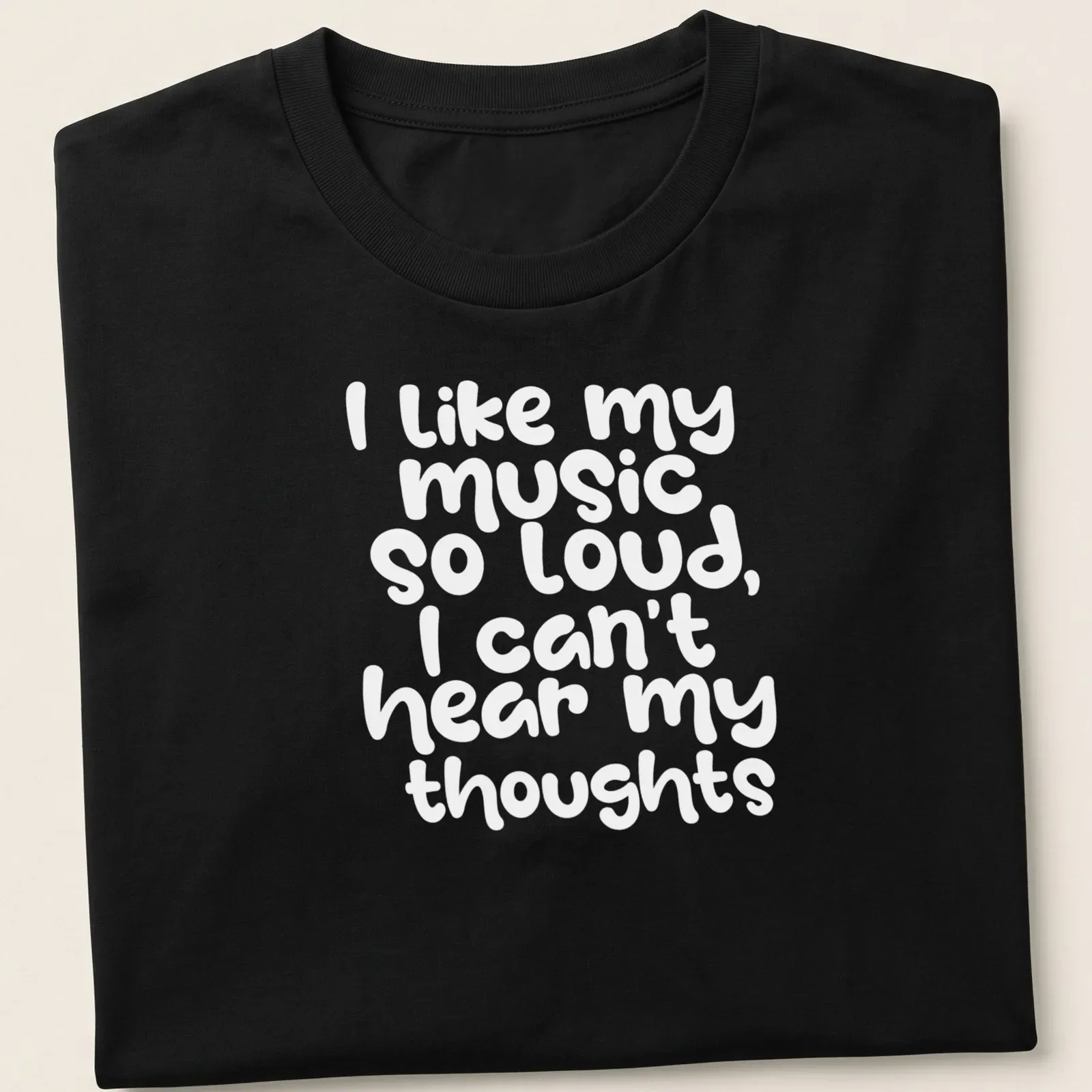 Playful handwritten text reads I like my music so loud I can't hear my thoughts — printed on a unisex t-shirt