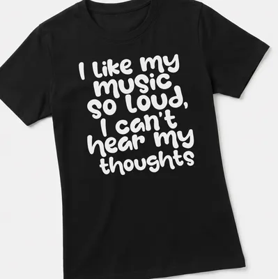 Playful handwritten text reads I like my music so loud I can't hear my thoughts — printed on a women's shirt