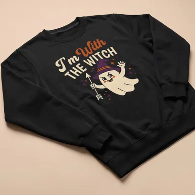 Playful cartoon ghost with witch hat and text 'I'm With THE WITCH' in Halloween colors — printed on a unisex sweatshirt