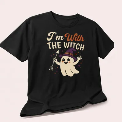 Playful cartoon ghost with witch hat and text 'I'm With THE WITCH' in Halloween colors — printed on a unisex t-shirt (angled view)