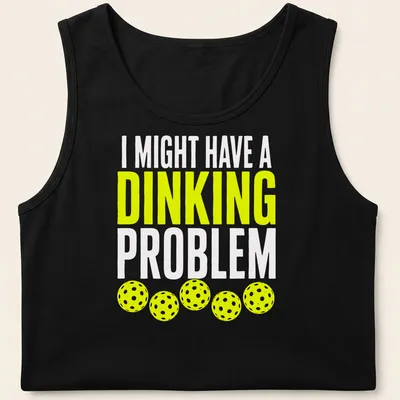 Retro bold text on a shirt saying 'I Might Have A Dinking Problem' with pickleball imagery. — printed on a tank top
