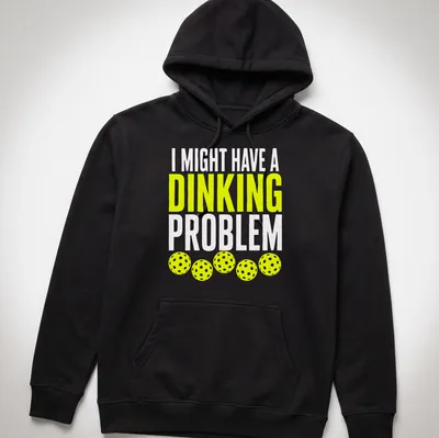 Retro bold text on a shirt saying 'I Might Have A Dinking Problem' with pickleball imagery. — printed on a unisex hoodie