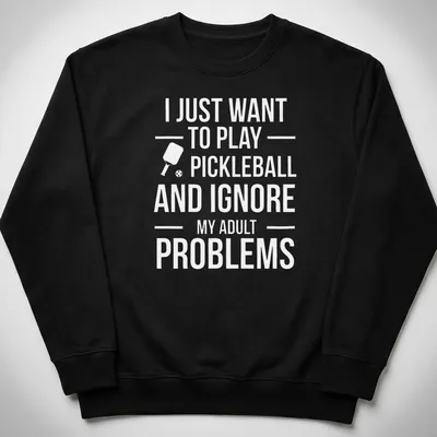 Typography t-shirt with the phrase about ignoring adult problems to play pickleball and a cartoon player — printed on a unisex sweatshirt