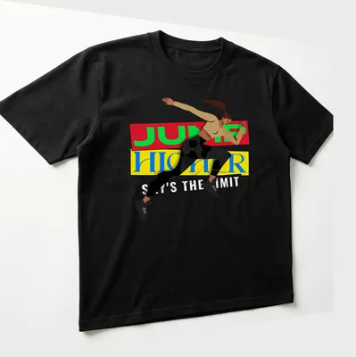 Bold graphic of a female athlete jumping with motivational text in red, yellow, and blue — printed on a unisex t-shirt (angled view)