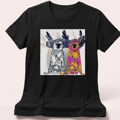 Pop art t-shirt featuring Kachina dolls and bold typography in various colors — printed on a women's shirt