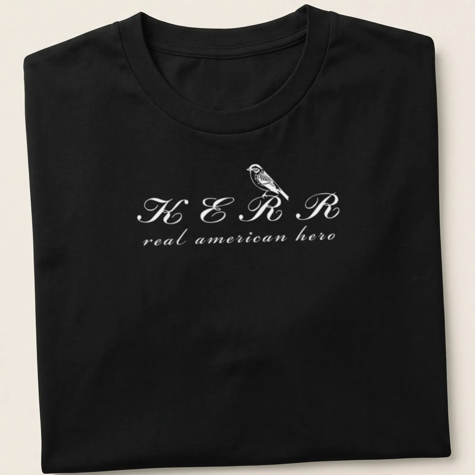 Simple line-art depiction of a bird with text KERR real american hero in white — printed on a unisex t-shirt