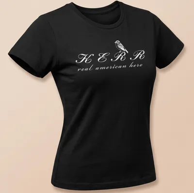 Simple line-art depiction of a bird with text KERR real american hero in white — printed on a women's shirt