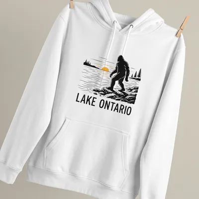 Silhouette of Bigfoot against a sunset with text Lake Ontario — printed on a unisex hoodie