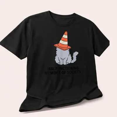 Cartoon cat with traffic cone hat and humorous text about society's norms — printed on a unisex t-shirt (angled view)