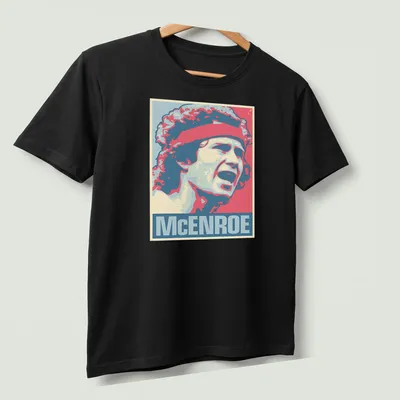 Vintage pop art portrait of John McEnroe in red, blue, cream, and pink — printed on a unisex t-shirt (angled view)