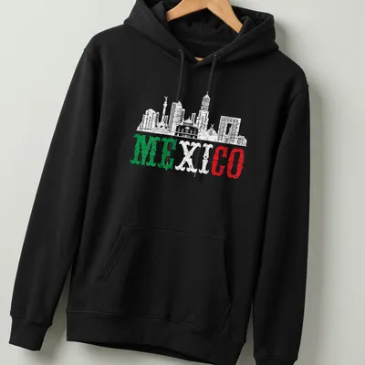 Distressed silhouette of Mexico City skyline with bold 'MEXICO' text in green, white, and red. — printed on a unisex hoodie