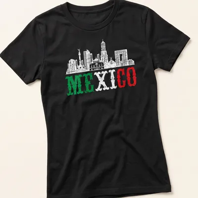 Distressed silhouette of Mexico City skyline with bold 'MEXICO' text in green, white, and red. — printed on a women's shirt
