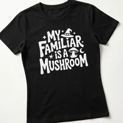 Whimsical illustration of a green and brown mushroom with the text 'My Familiar Is A Mushroom' — printed on a women's shirt