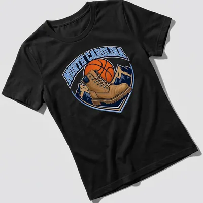 Vintage North Carolina Basketball T-shirt featuring a work boot and basketball graphic — printed on a women's shirt