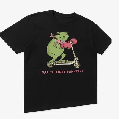 Cartoon frog on a scooter with text saying 'Off to Fight Bad Cells' in playful colors. — printed on a unisex t-shirt (angled view)